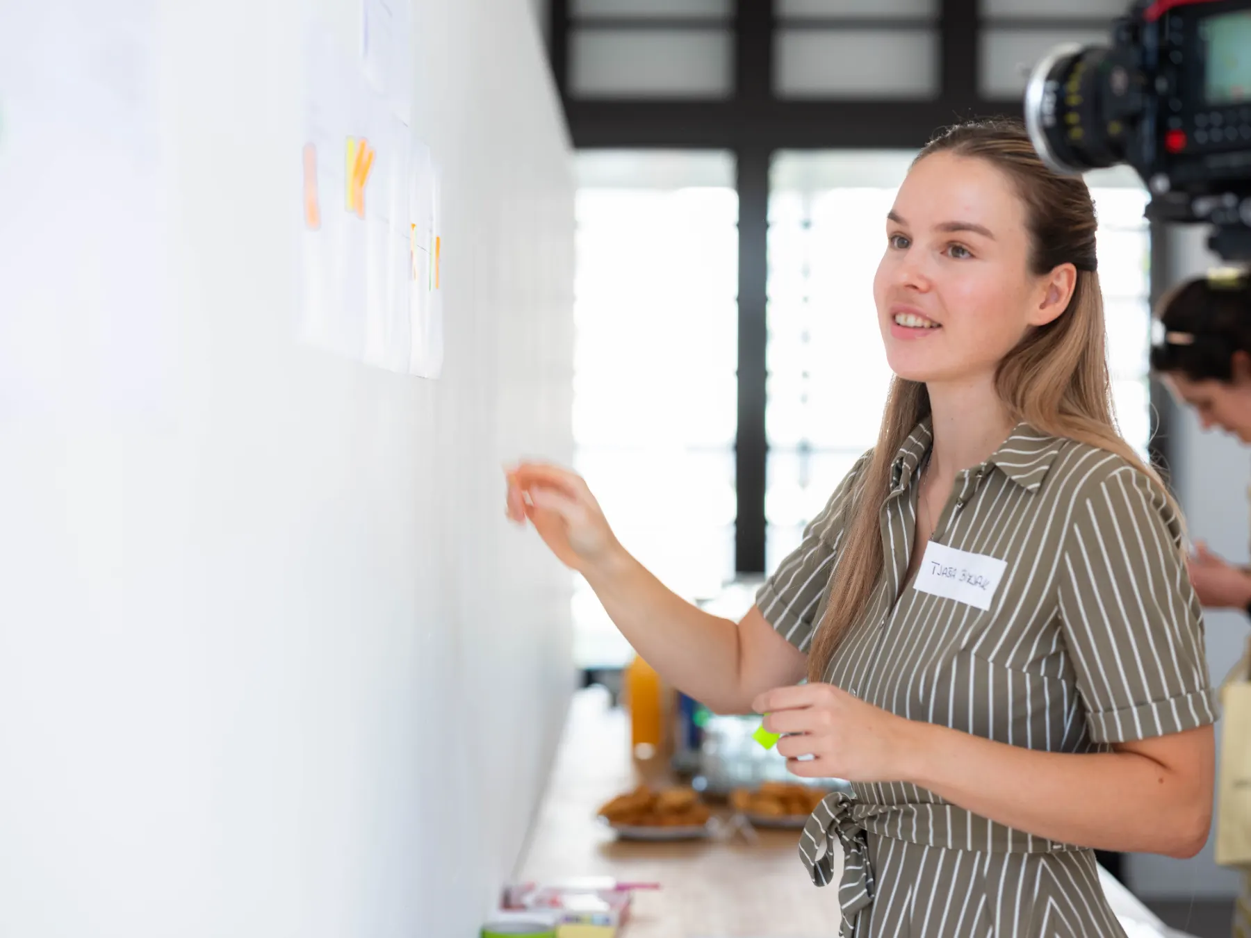 A member presenting workshop notes on a wall